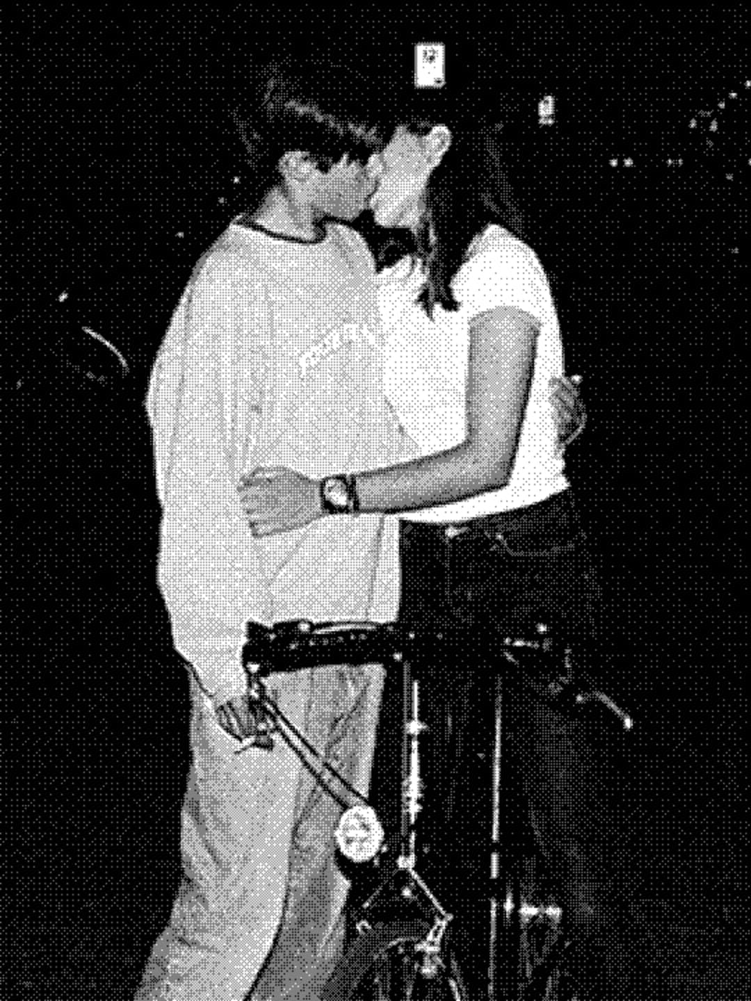 Two people kissing outdoors