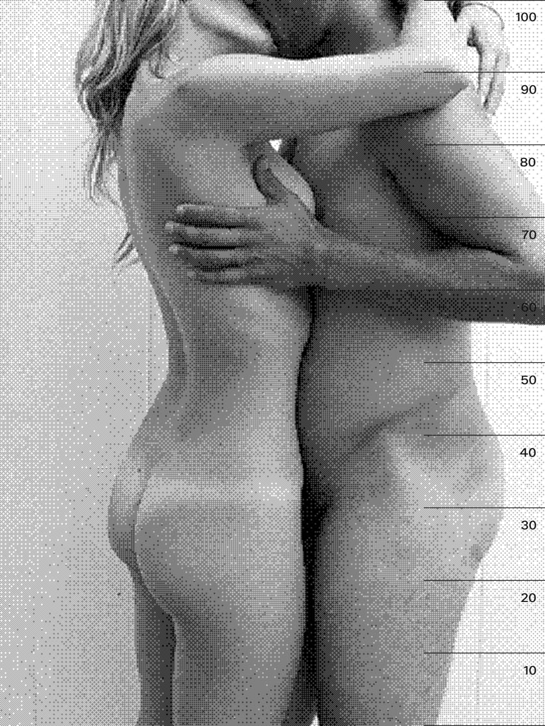 Two people embracing in front of a height chart